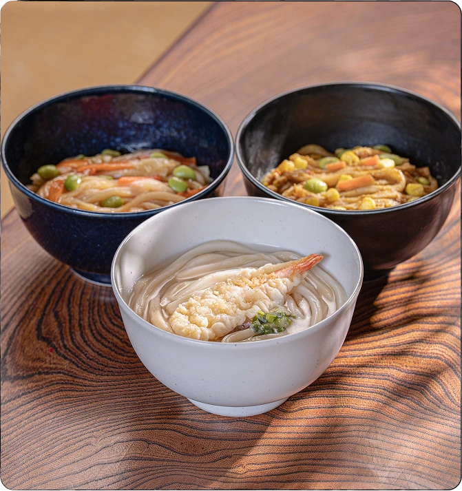 A person eating udon at a table