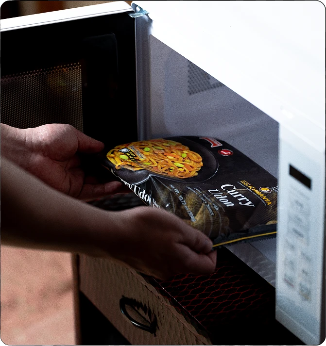 A TableMark udon package being placed in a microwave